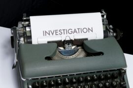 Sex trafficking initiatives, whether anti- or counter- require investigation and collaboration as this image implies. We see an older typewriter with a piece of paper coming up with the word "Investigation" typed on it.