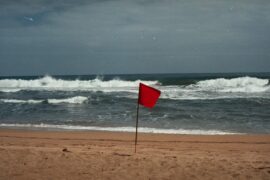 The red flag is a sign of suspicious activities. This flag on the beach alerts swimmers to dangers in the water, just like red flags in your community help alert you to potential emergencies.