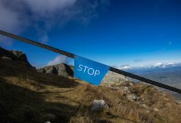 Boundaries are designed to keep us safe. Teaching teens to set healthy boundaries helps them keep themselves safe. This photo shows a blue sign with the word STOP on it to prevent people from being hurt on this rocky terrain.